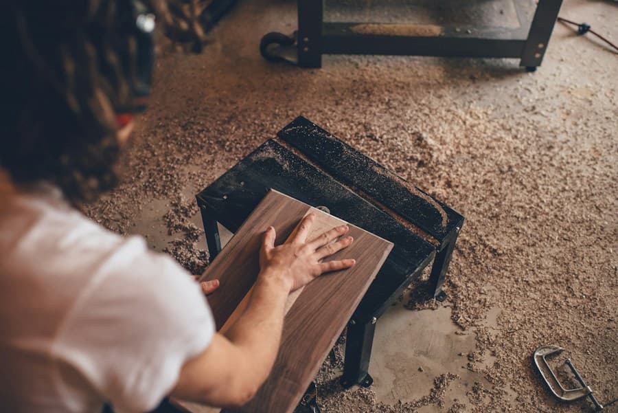 A woodworker shaping a board in a workshop